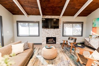a living room with a couch and a table and a fireplace